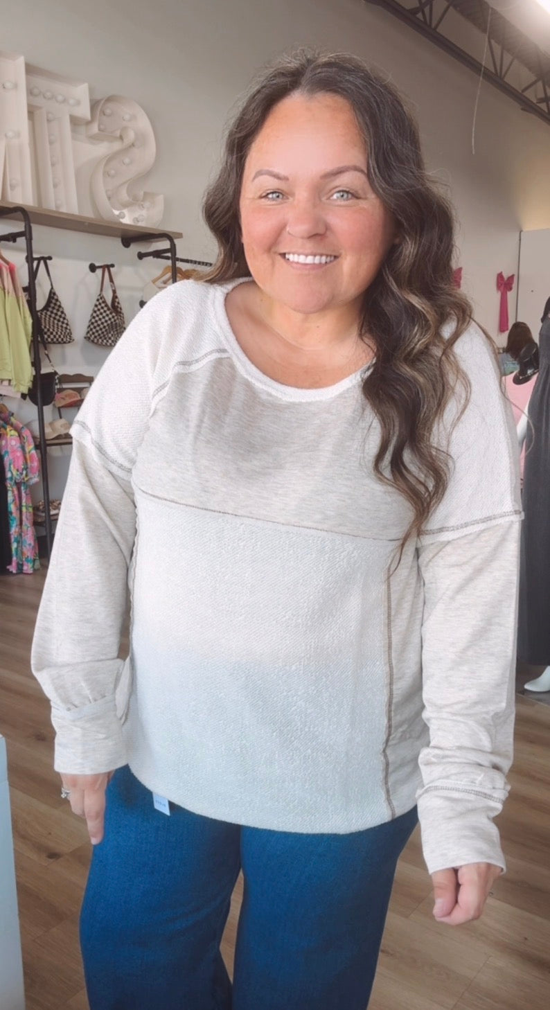 Exposed hem creamy long sleeve top