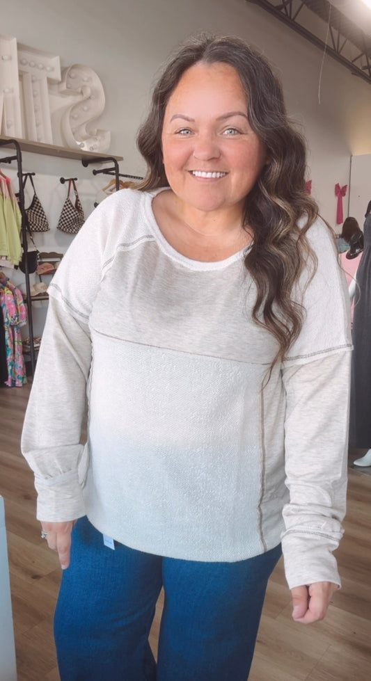 Exposed hem creamy long sleeve top