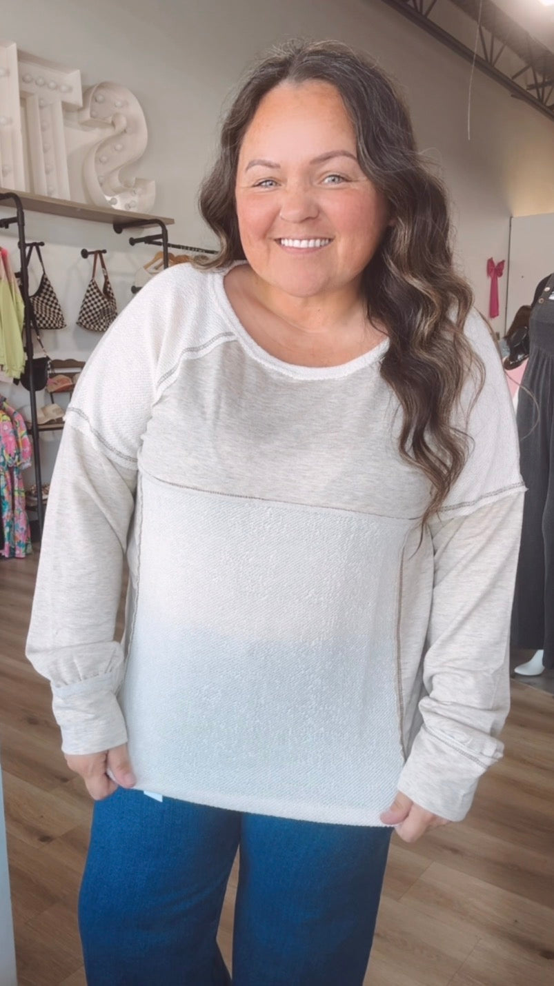 Exposed hem creamy long sleeve top